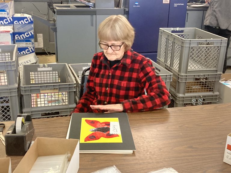Employee at desk admiring butterfly art
