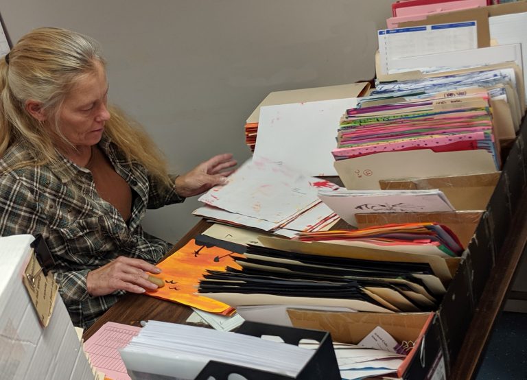 Tina sitting at her desk