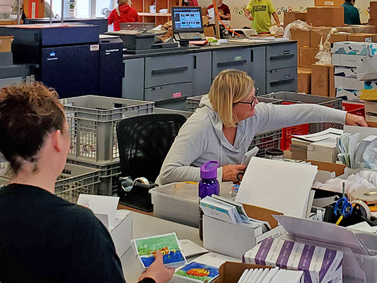 Employees busy organizing artwork