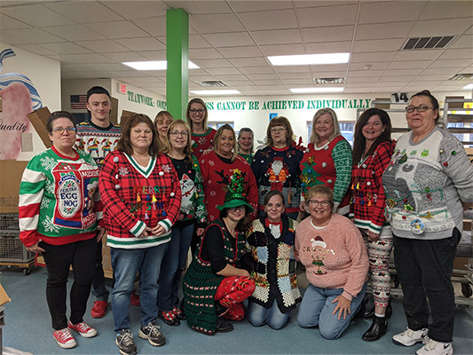 Employees in Christmas sweaters