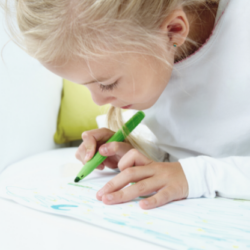 blonde haired little girl with green marker