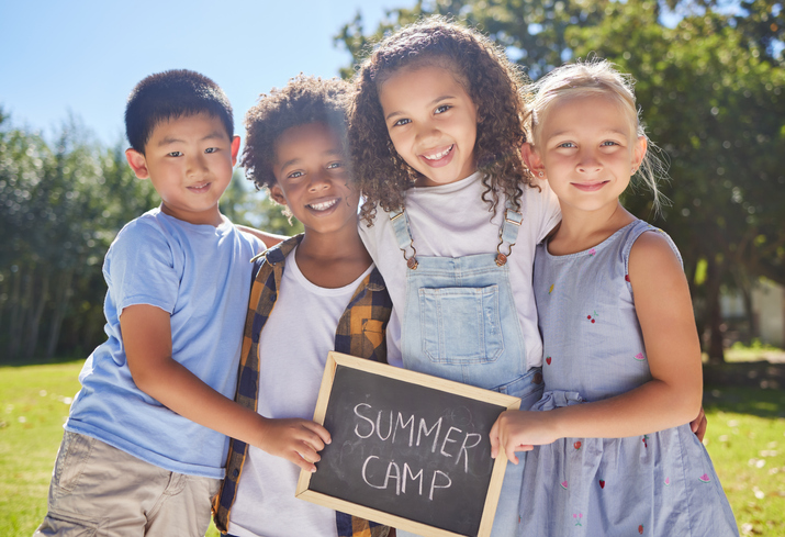 kids holding Summer Camp sign