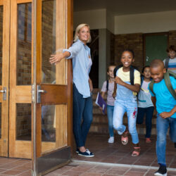 teacher opening door for students