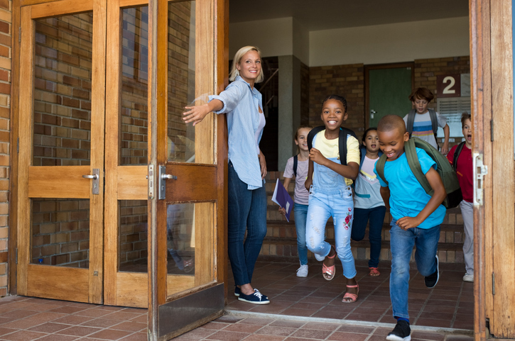 teacher opening door for students